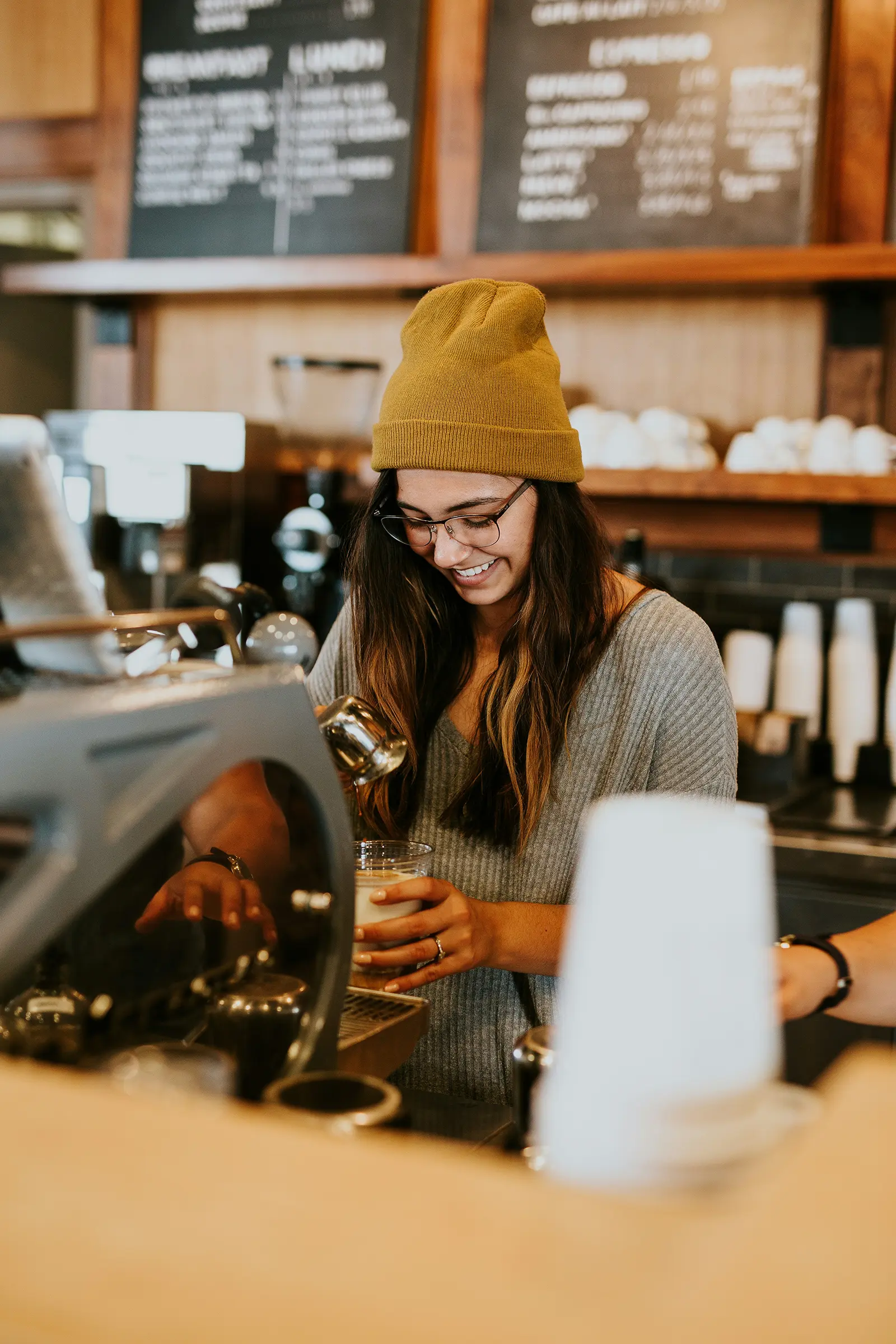 A barista serving coffee in an Australian café.