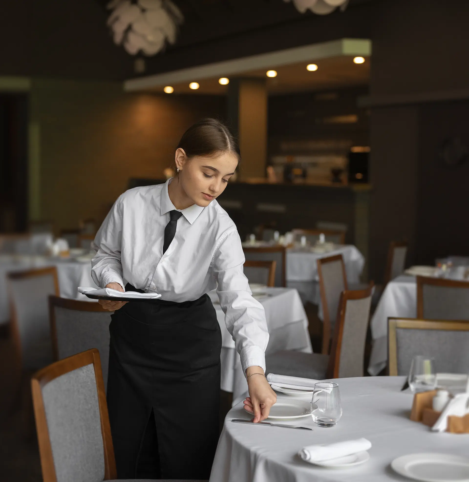 Waiting staff serving guests in a restaurant.